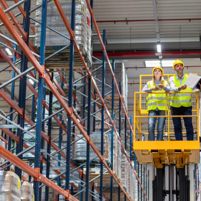 custom installation service people on lift by shelves