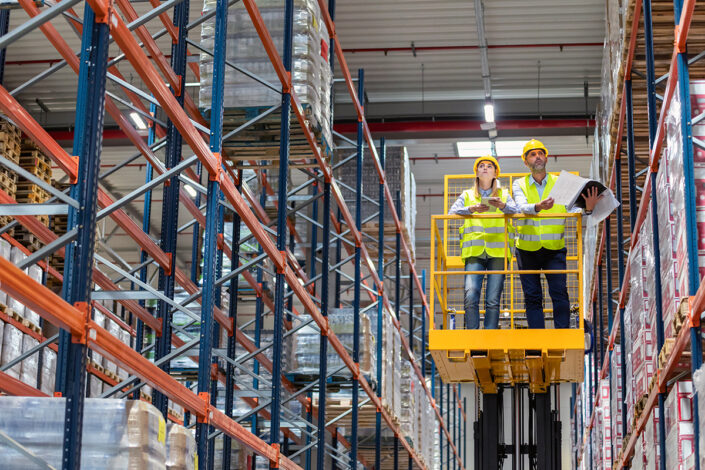 custom installation service people on lift by shelves